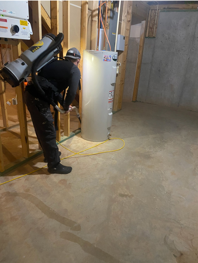 Technician performing mold remediation in a basement